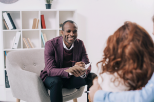 Person listening to their therapist in an individual therapy program session